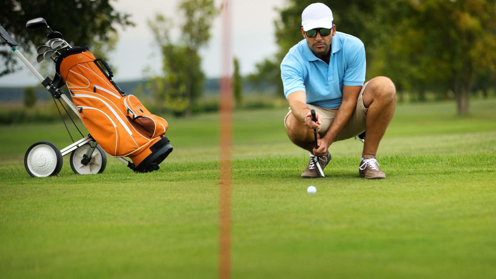 Golf carts and maintenance equipment on a course, highlighting coverage for equipment and business property for Ontario golf courses.