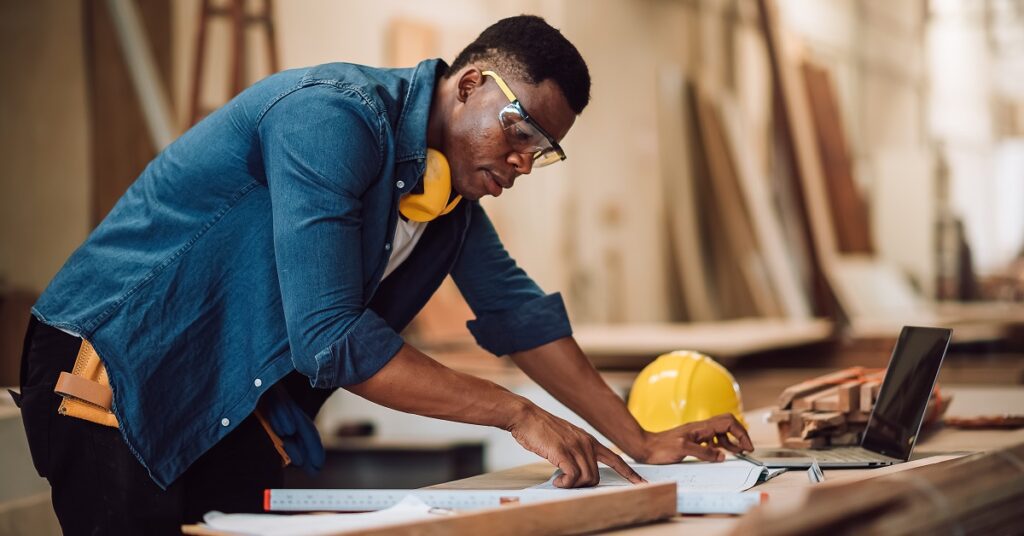 Ontario contractor reviewing building plans liability and risk insurance for construction