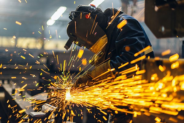 Workers in an Ontario manufacturing plant performing tasks on the line representing liability and business interruption insurance for industrial enterprises.
