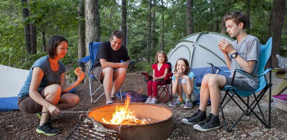 Family enjoying an outdoor camping experience beside their RV in Ontario, symbolizing protection and peace of mind for RV owners