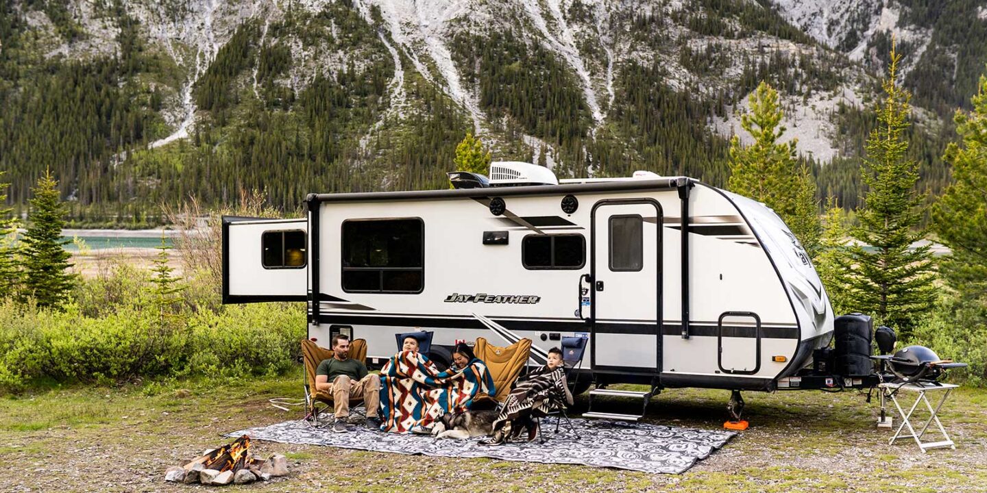 Travel trailer parked by a lake in Ontario, illustrating coverage needs for towable recreational vehicles