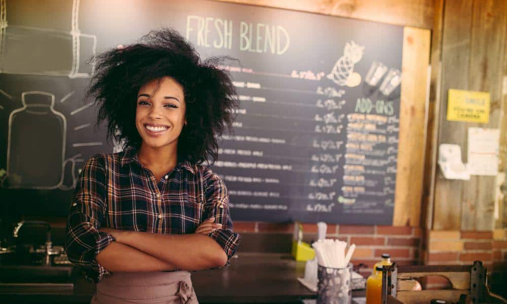 Small business owner in Ontario consulting with an insurance broker over policy documents, symbolizing tailored insurance solutions for retail & small business owners