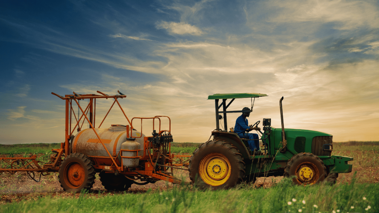 Tractor working in Ontario crop field farm equipment and property insurance for agricultural operations
